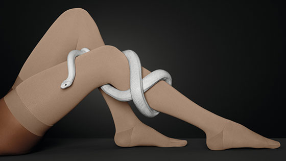 Juzo Move One leg with a compression stocking. A snake winds around the leg.