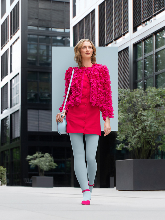 Icy Blue A woman with lymphoedema walks through the city wearing an Icy Blue compression garment with a pink dress