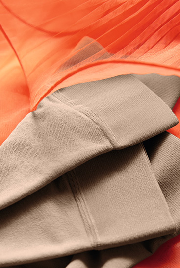 3. Lifestyle image Juzo Inspiration Juzo Inspiration tights lie on an orange tulle Dress
