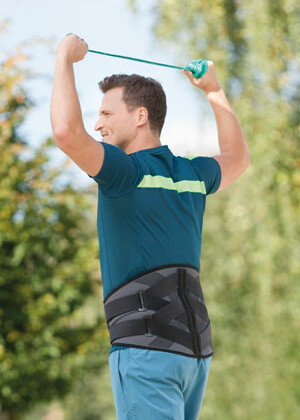Stylish back orthoses Man exercising with orthosis