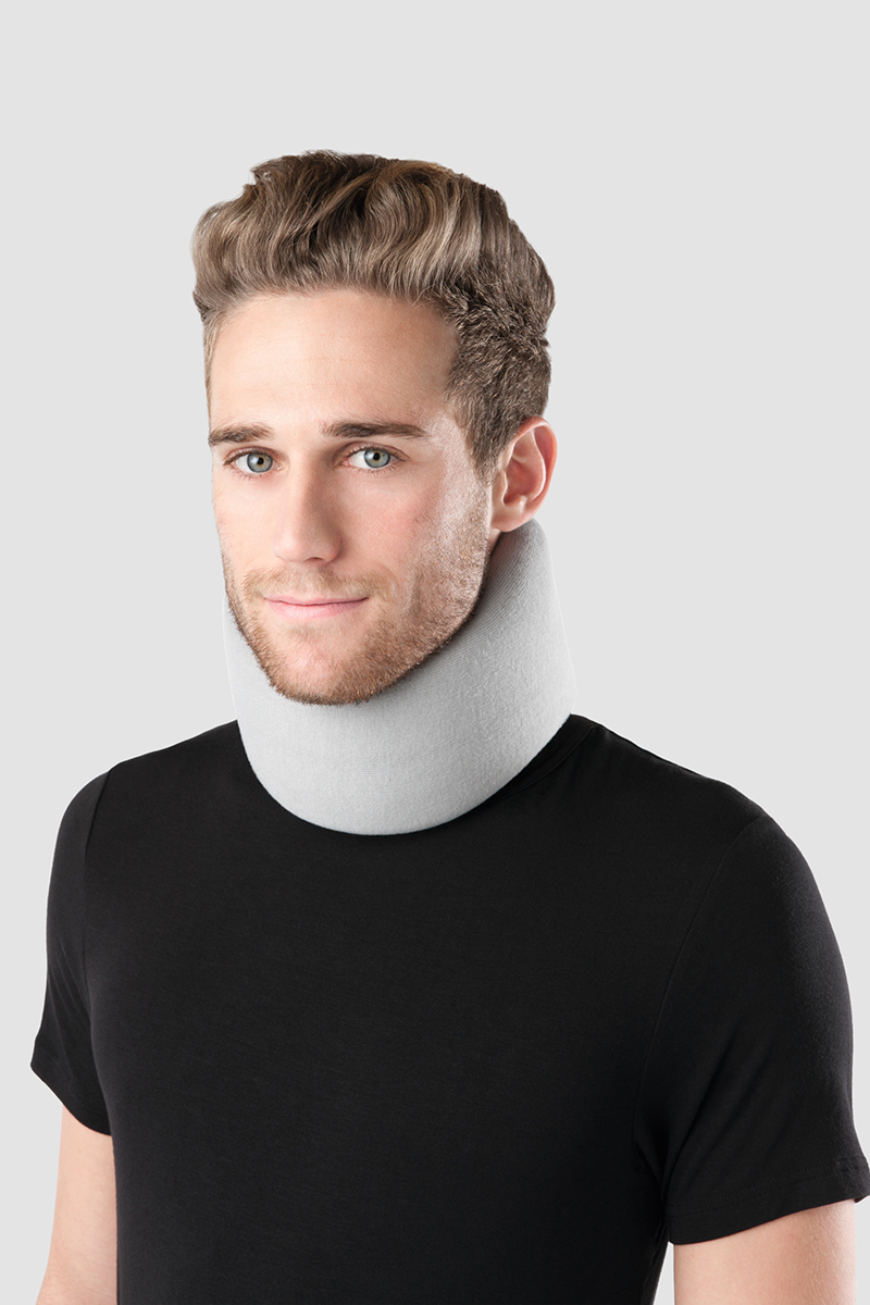 A man is wearing a Juzo cervical support around his neck.