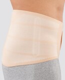 3rd product image Beige, side Man wearing the JuzoPro Lumbal back orthosis in straight shape