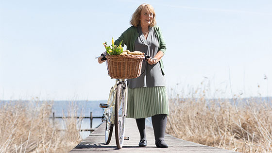 A woman on a jetty is wearing compression stockings A woman on a jetty is wearing compression stockings