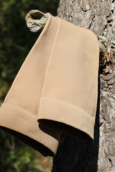 4. Lifestyle image Juzo Adventure Juzo Adventure stocking in sesame hanging over a branch