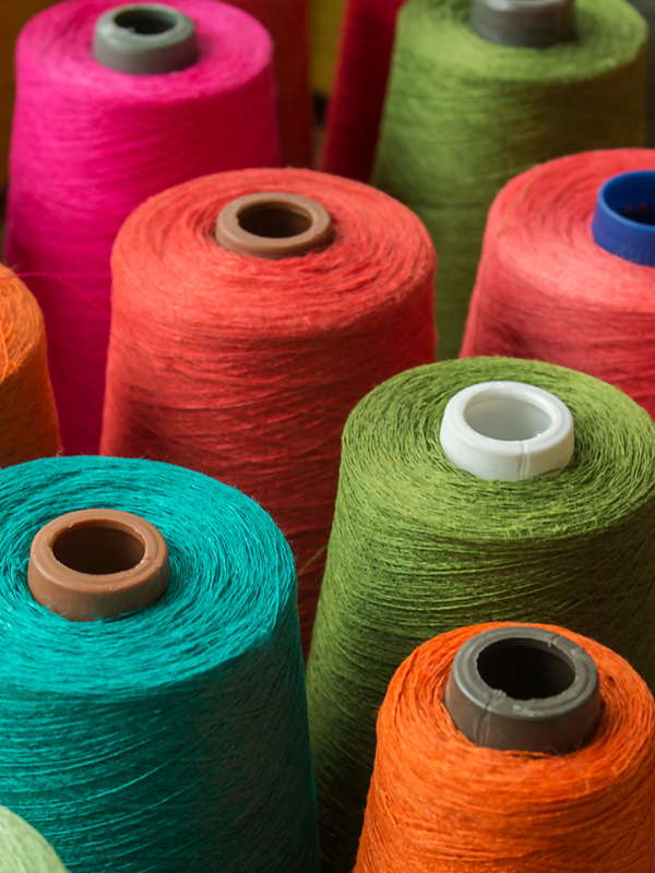 Bobbins with different coloured threads